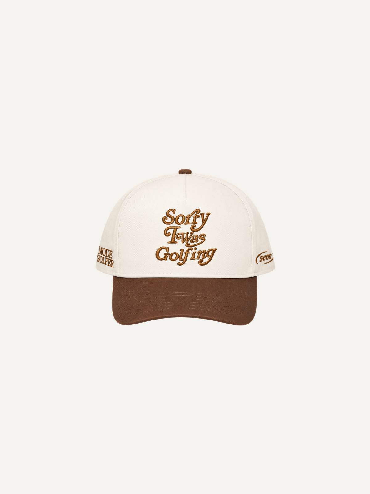 Cream and brown “Sorry I Was Golfing” cap with brown embroidery, front view