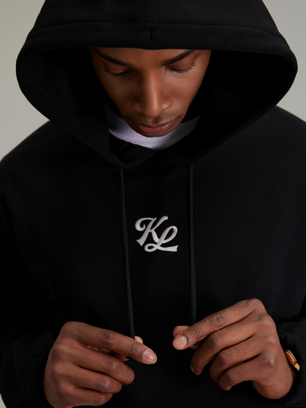 Black Club Emblem hoodie with logo detail, close-up, Khalhon