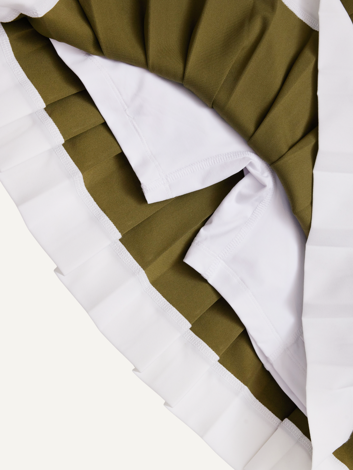 Women’s olive green golf pleated skirt pleat detail with white contrast hem, Khalhon