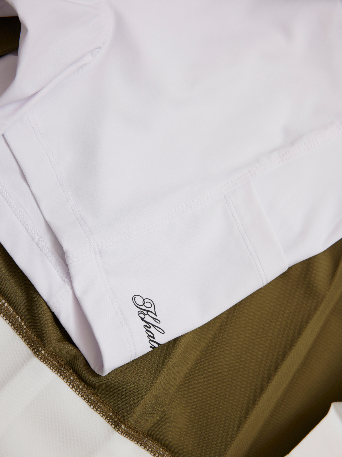 Women’s olive green golf pleated skirt pleat detail with white contrast hem, Khalhon