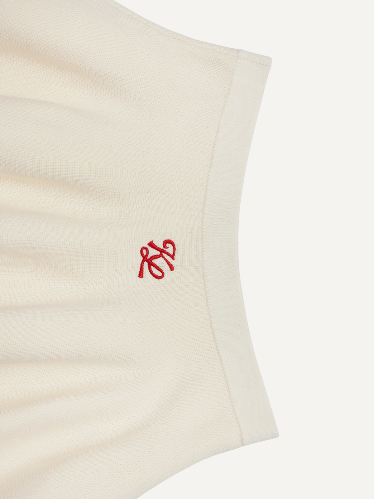 Women’s cream golf knit skirt embroidered logo detail with red hem, Khalhon