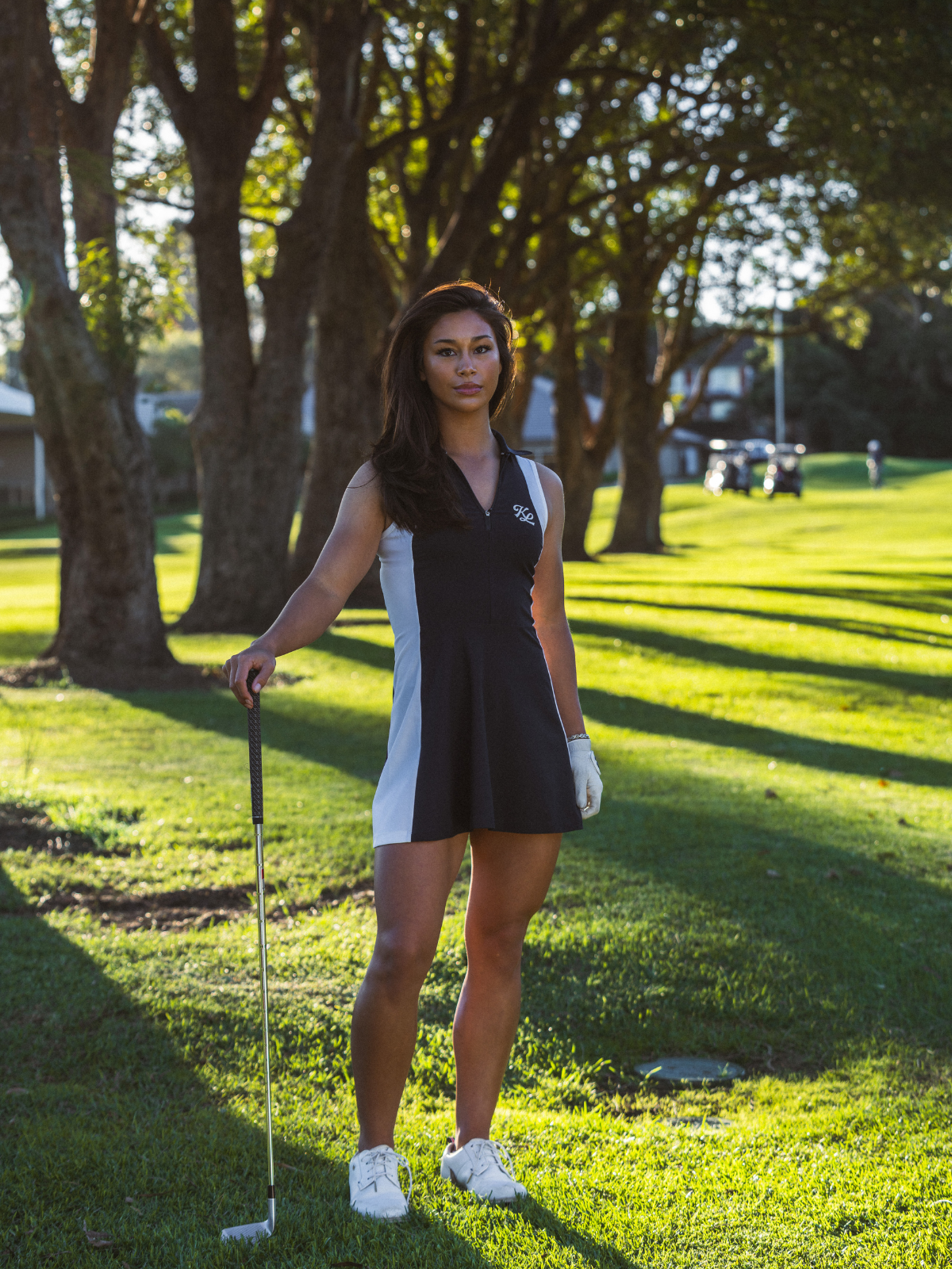 Woman wearing Khalhon' Contour Dress in black and white, full length shot on golf course