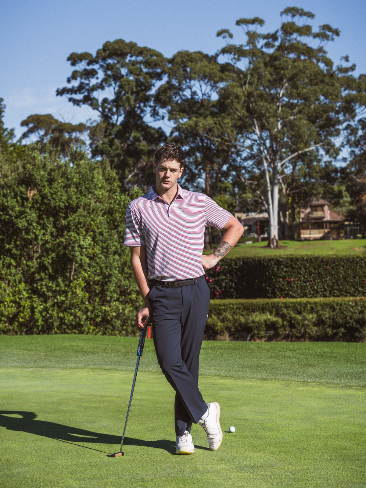Man wearing Khalhon' Men's Performance Pants in navy, on golf course