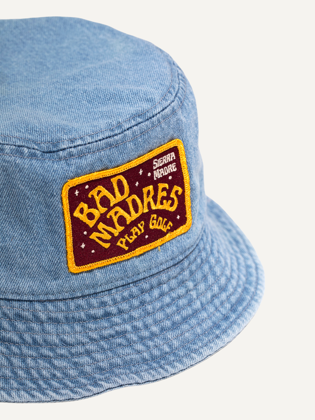 Light blue bucket hat with embroidered “Bad Madres” patch detail, Sierra Madre