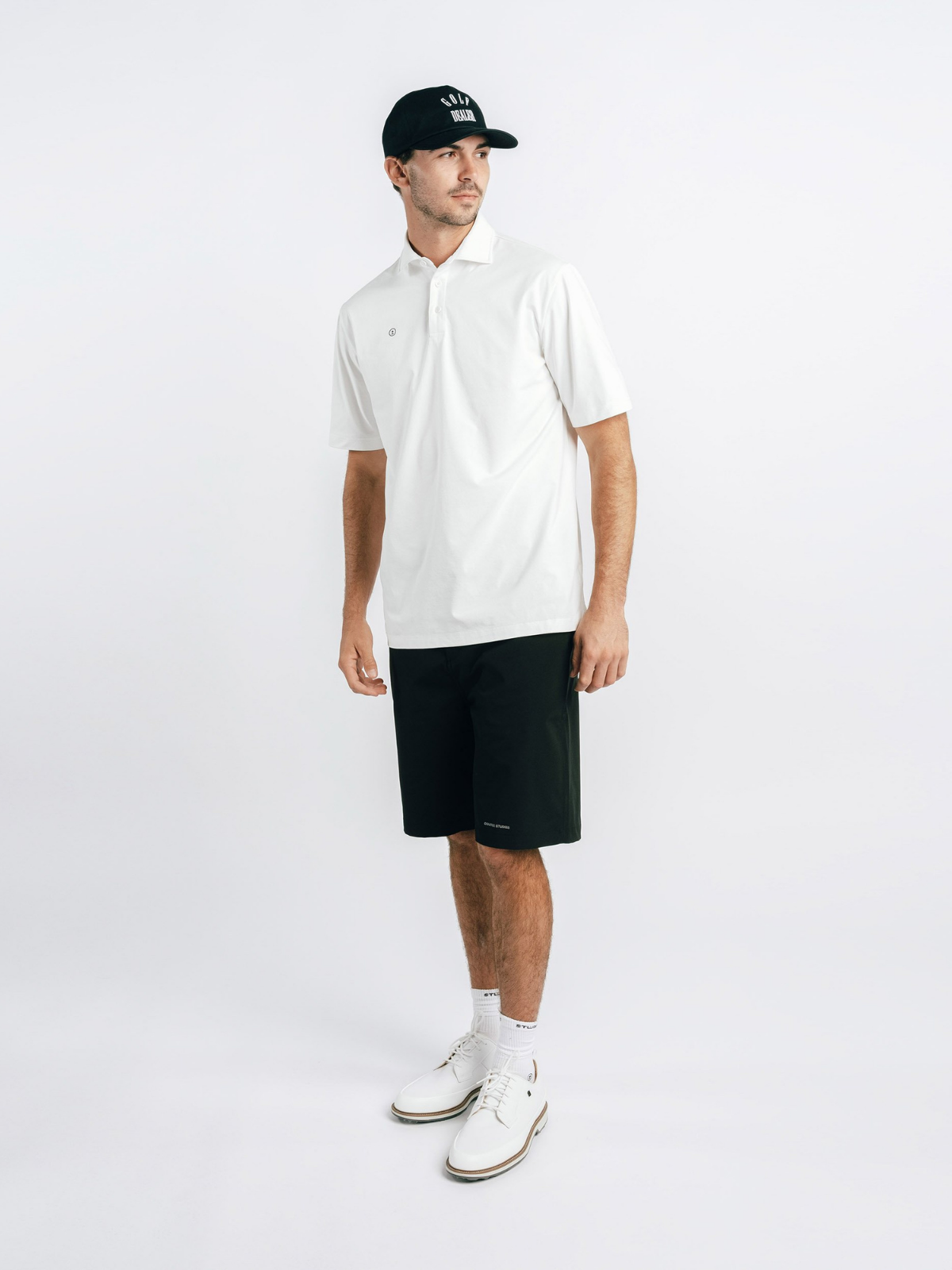 Model wearing black Alpina Performance Shorts, Students Golf, front view