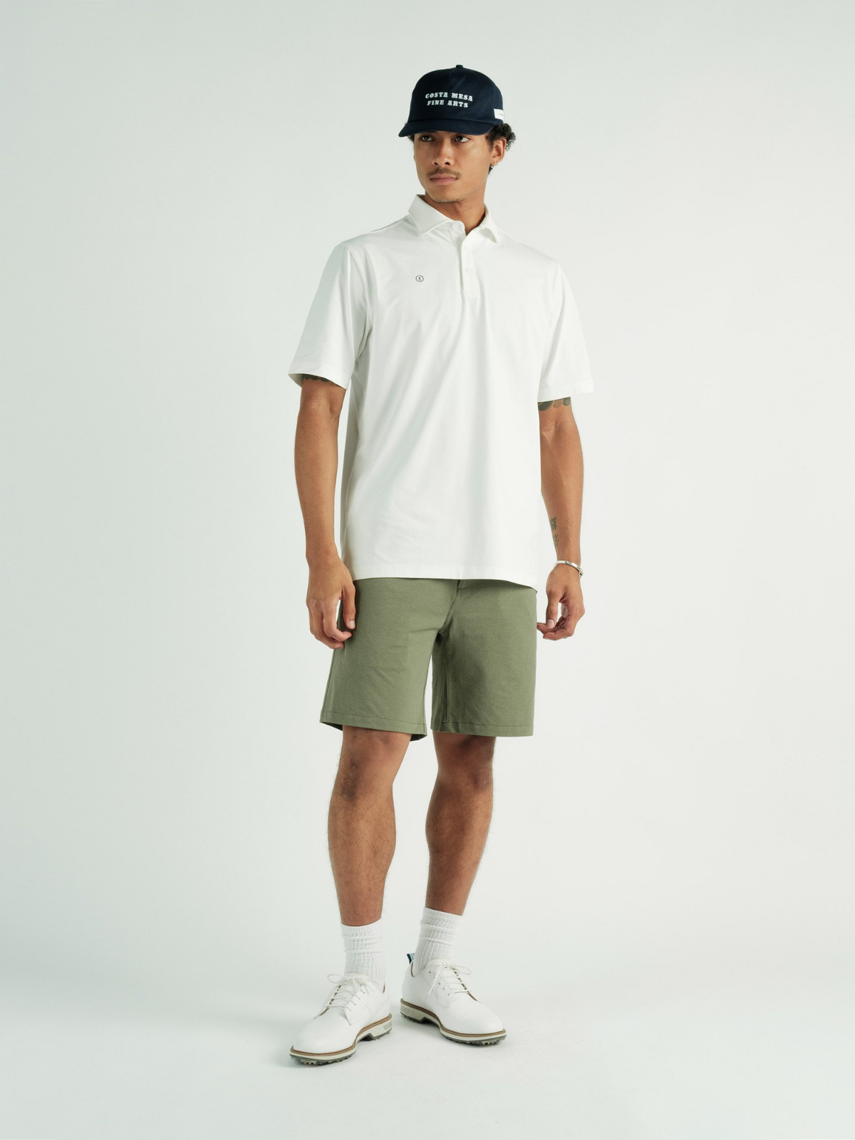 Model wearing white Chaperone Polo, Students Golf, alternate front view